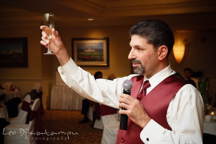 Best man raising champagne glass for toast. Baywood Clubhouse at Baywood Greens Wedding, St. Christophers Church Wedding, Kent Island, Eastern Shore Maryland