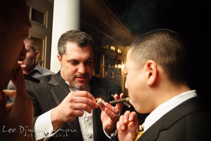 Groom help light up bride's brother's cigar. Baywood Clubhouse at Baywood Greens Wedding, St. Christophers Church Wedding, Kent Island, Eastern Shore Maryland