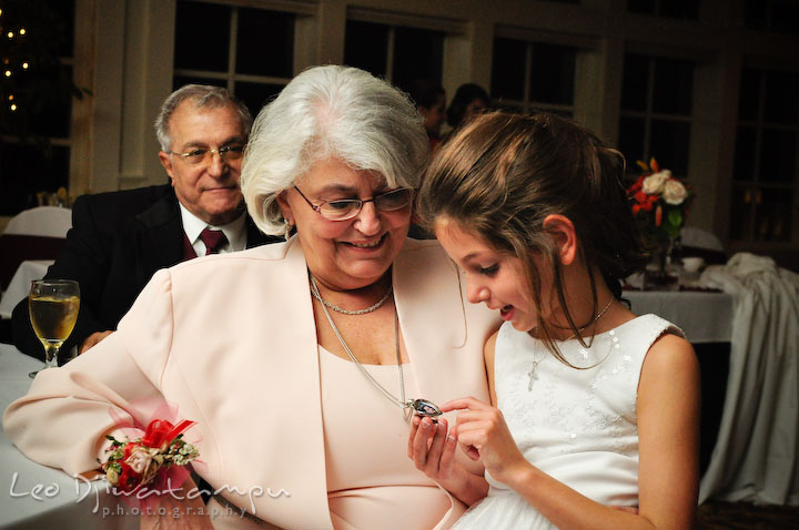 Flower girl looking at mother of groom's locket. Baywood Clubhouse at Baywood Greens Wedding, St. Christophers Church Wedding, Kent Island, Eastern Shore Maryland