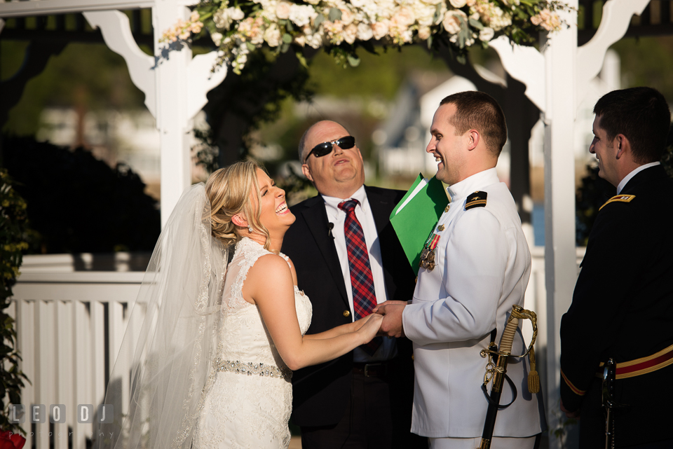 Kent Manor Inn wedding ceremony bride and groom laughing during wedding vow photo by Leo Dj Photography