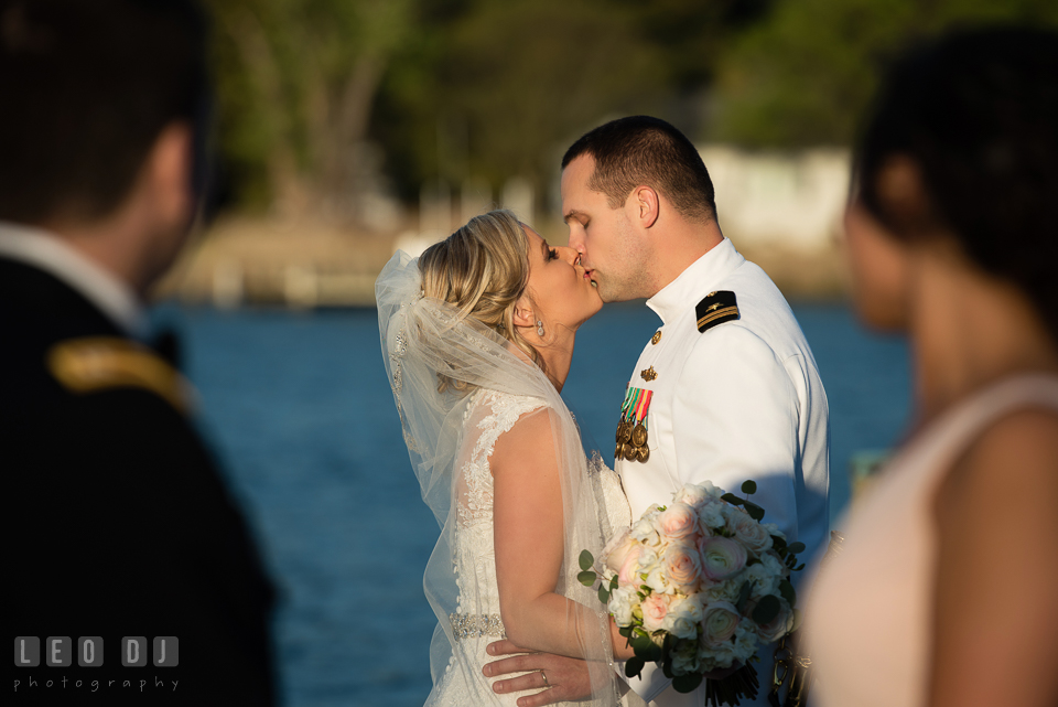 Kent Manor Inn bride and groom kissing seen by Maid of Honor and Best Man photo by Leo Dj Photography