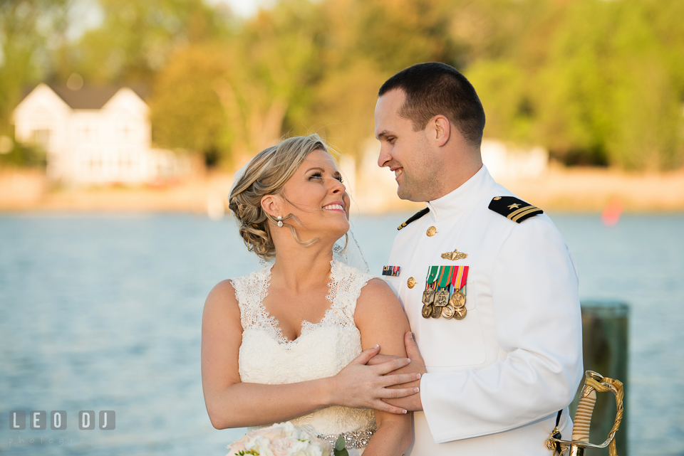 Kent Manor Inn groom embracing bride on the dock with water view photo by Leo Dj Photography