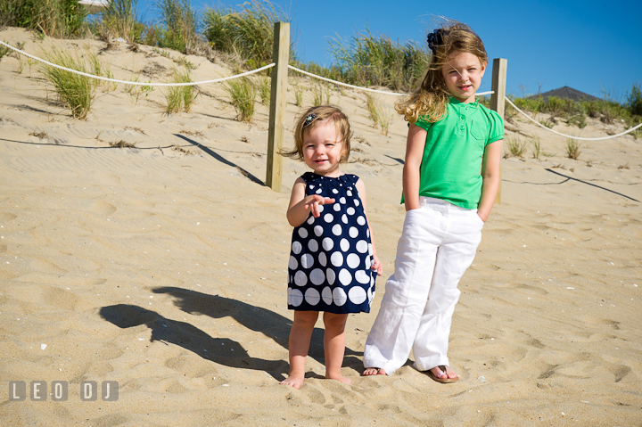 Two toddler girls posing on the beach. Ocean City, Maryland Eastern Shore candid children and family lifestyle photo session by photographers of Leo Dj Photography. http://leodjphoto.com