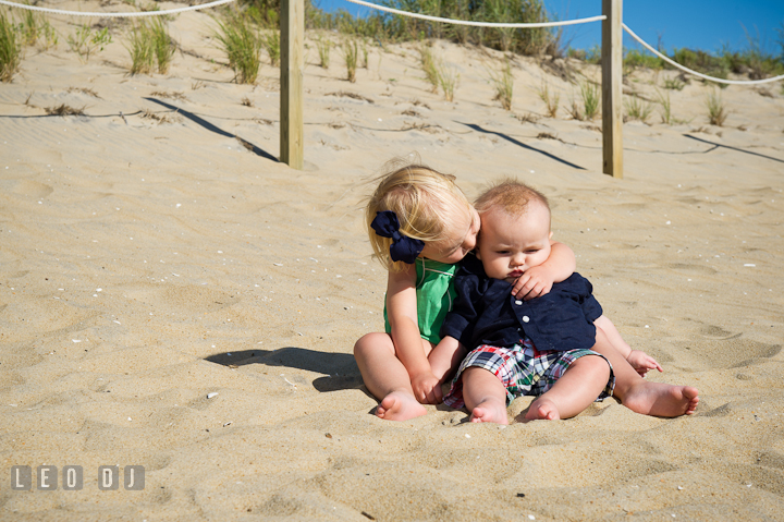 Toddler girl hugging his baby brother. Ocean City, Maryland Eastern Shore candid children and family lifestyle photo session by photographers of Leo Dj Photography. http://leodjphoto.com