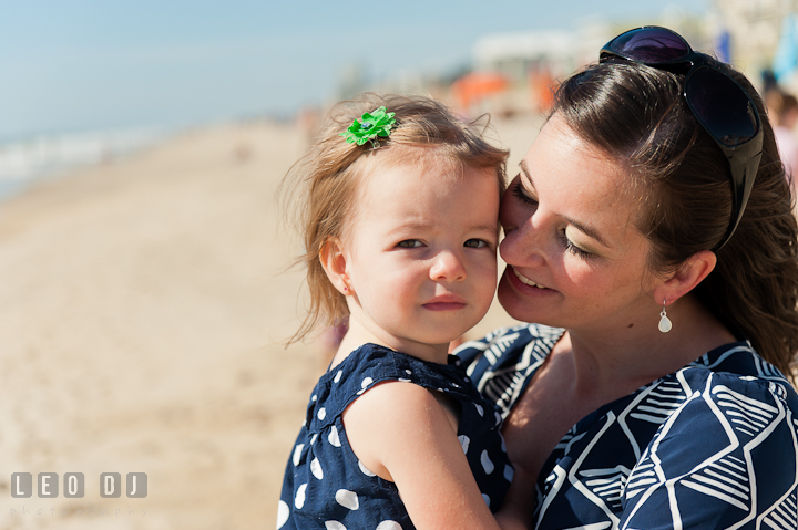 Mother cuddling her little girl. Ocean City, Maryland Eastern Shore candid children and family lifestyle photo session by photographers of Leo Dj Photography. http://leodjphoto.com