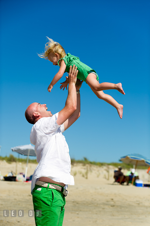 Father playing with his daughter lift her up in the air. Ocean City, Maryland Eastern Shore candid children and family lifestyle photo session by photographers of Leo Dj Photography. http://leodjphoto.com