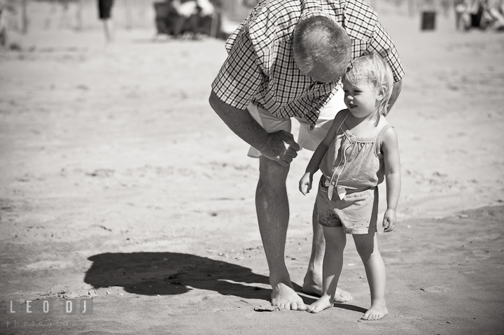 Grandfather talking to his granddaughter. Ocean City, Maryland Eastern Shore candid children and family lifestyle photo session by photographers of Leo Dj Photography. http://leodjphoto.com