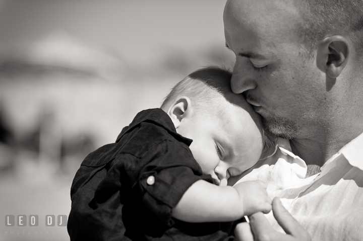 Father kissing his baby boy. Ocean City, Maryland Eastern Shore candid children and family lifestyle photo session by photographers of Leo Dj Photography. http://leodjphoto.com