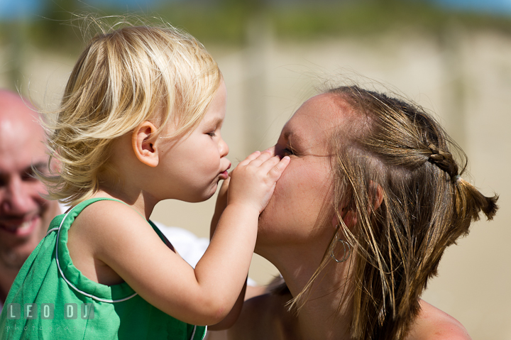 Girl trying to kiss Mommy's nose. Ocean City, Maryland Eastern Shore candid children and family lifestyle photo session by photographers of Leo Dj Photography. http://leodjphoto.com