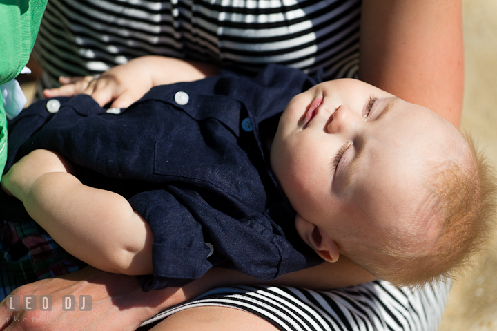 Baby boy sleeping on Mommy's lap. Ocean City, Maryland Eastern Shore candid children and family lifestyle photo session by photographers of Leo Dj Photography. http://leodjphoto.com