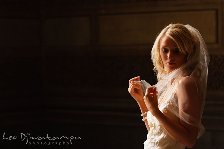 Bride holding her veil, looking down. Wedding bridal portrait photo workshop with Cliff Mautner. Images by Leo Dj Photography