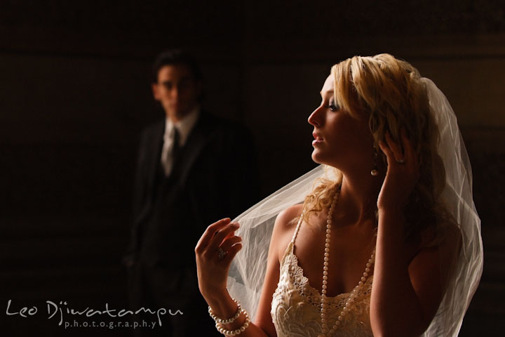 Bride playing with veil, groom looking from a distance. Wedding bridal portrait photo workshop with Cliff Mautner. Images by Leo Dj Photography