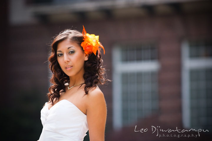 Bride with orange flower on hair, posing for the camera. Wedding bridal portrait photo workshop with Cliff Mautner. Images by Leo Dj Photography