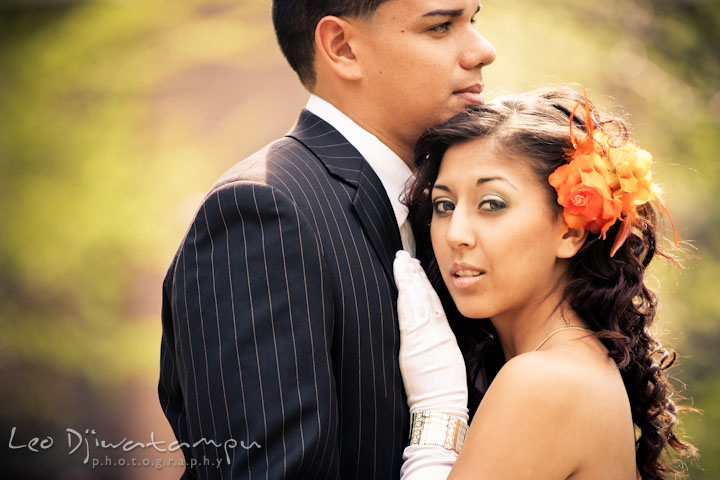 Bride with orange flower cuddling on groom's chest. Wedding bridal portrait photo workshop with Cliff Mautner. Images by Leo Dj Photography