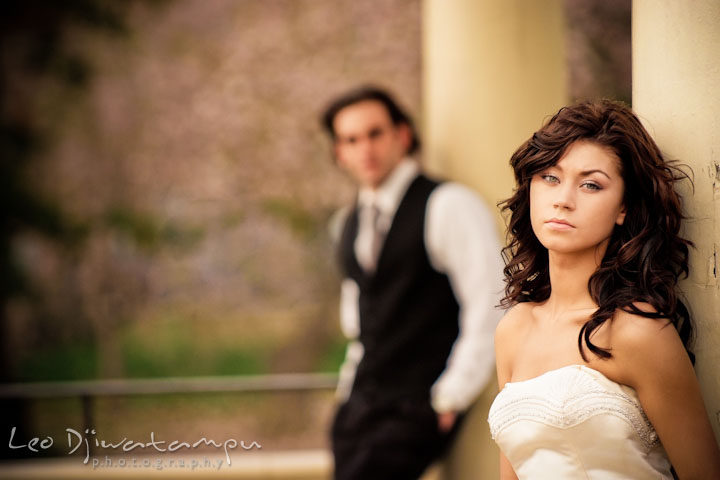 Bride posing and groom looking in the background. Wedding bridal portrait photo workshop with Cliff Mautner. Images by Leo Dj Photography