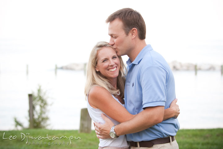 Husband kissing his wife. Edgewater, Annapolis, Eastern Shore Maryland fun and candid children and family lifestyle photo session by photographers of Leo Dj Photography.