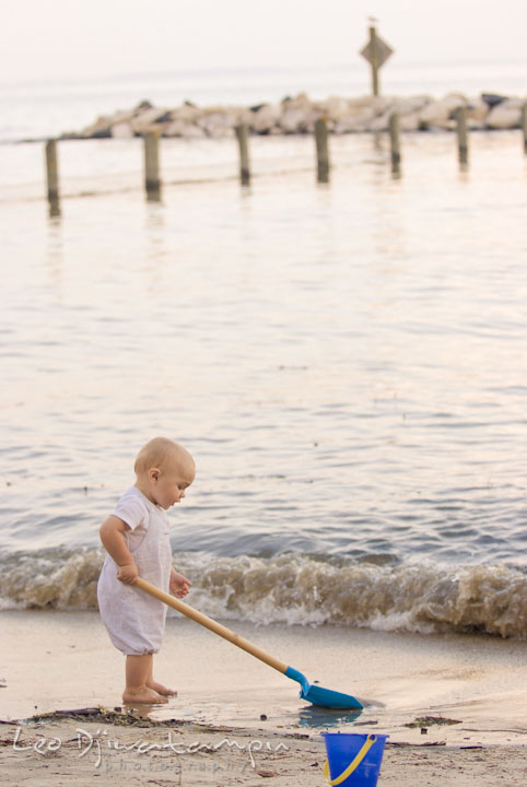 Baby boy playing sand at the beach. Edgewater, Annapolis, Eastern Shore Maryland fun and candid children and family lifestyle photo session by photographers of Leo Dj Photography.