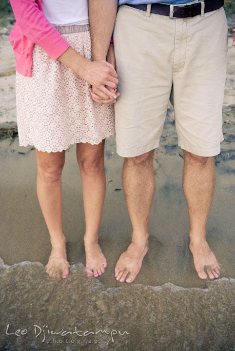 Wife and her husband holding hands, barefoot on the sand, feeling the wave. Edgewater, Annapolis, Eastern Shore Maryland fun and candid children and family lifestyle photo session by photographers of Leo Dj Photography.