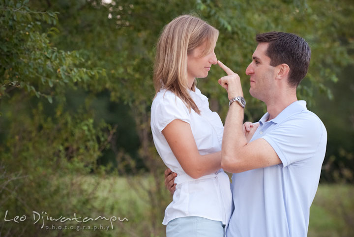A guy touched his fiancée's nose. Edgewater, Annapolis, Eastern Shore Maryland fun and candid children and family lifestyle photo session by photographers of Leo Dj Photography.