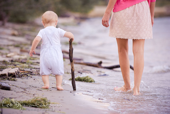 Toddler boy walking with a stick. Edgewater, Annapolis, Eastern Shore Maryland fun and candid children and family lifestyle photo session by photographers of Leo Dj Photography.