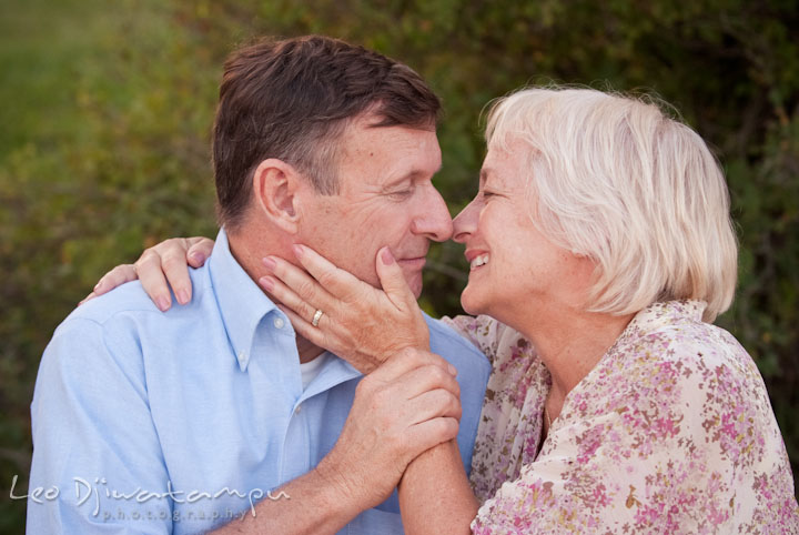 Grandparents cuddling, smiling, and showing their love. Edgewater, Annapolis, Eastern Shore Maryland fun and candid children and family lifestyle photo session by photographers of Leo Dj Photography.