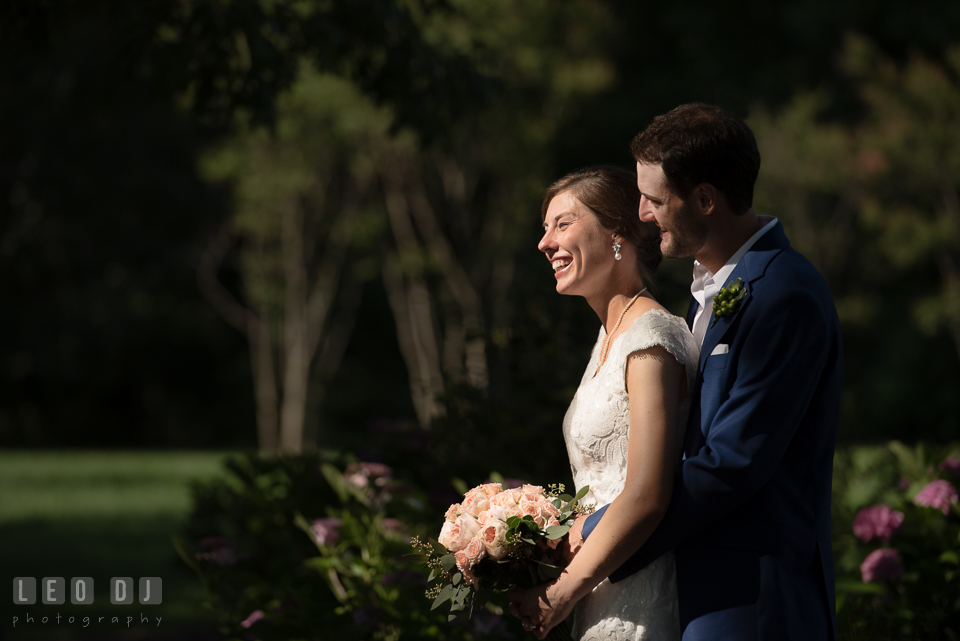 Groom hugging Bride from behind. The Oaks Waterfront Inn wedding, St Michaels, Eastern Shore, Maryland, by wedding photographers of Leo Dj Photography. http://leodjphoto.com