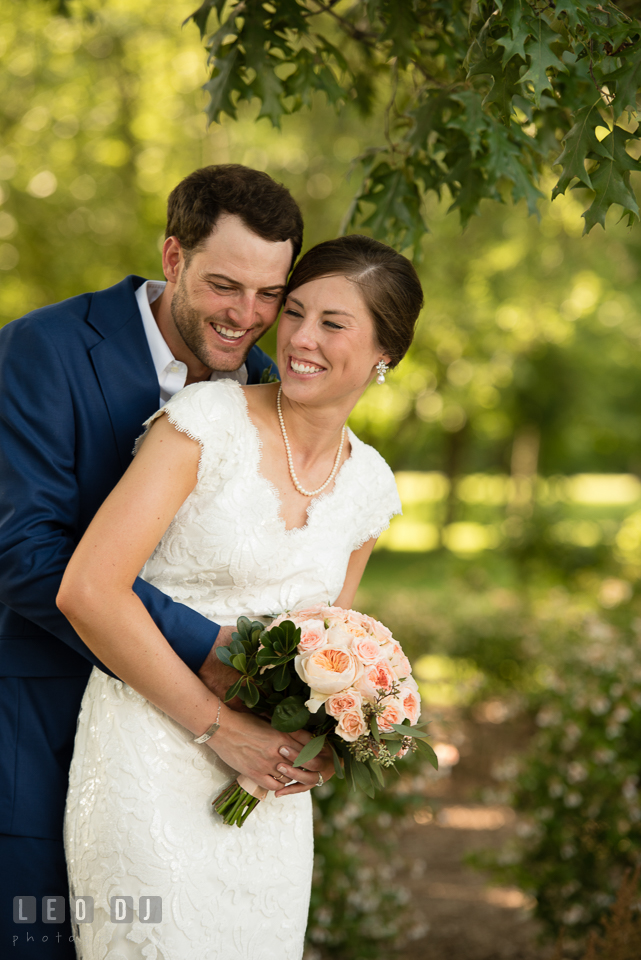 Groom hugging Bride from Behind, laughing together. The Oaks Waterfront Inn wedding, St Michaels, Eastern Shore, Maryland, by wedding photographers of Leo Dj Photography. http://leodjphoto.com