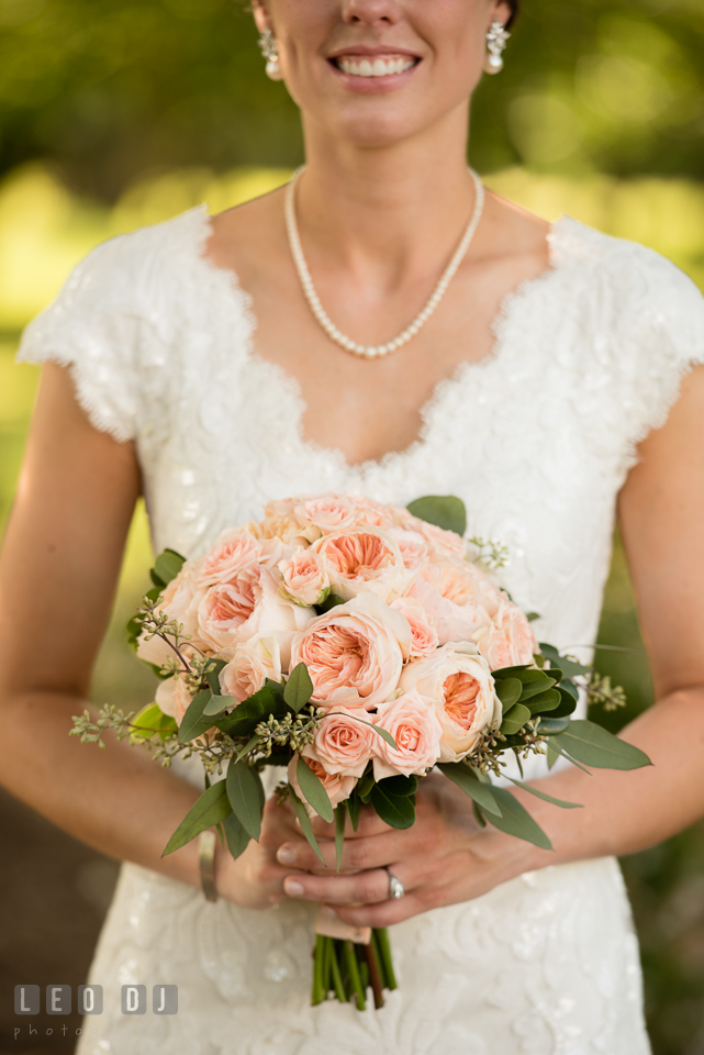 Bride holding wedding flower bouquet by florist Sophie's Poseys. The Oaks Waterfront Inn wedding, St Michaels, Eastern Shore, Maryland, by wedding photographers of Leo Dj Photography. http://leodjphoto.com