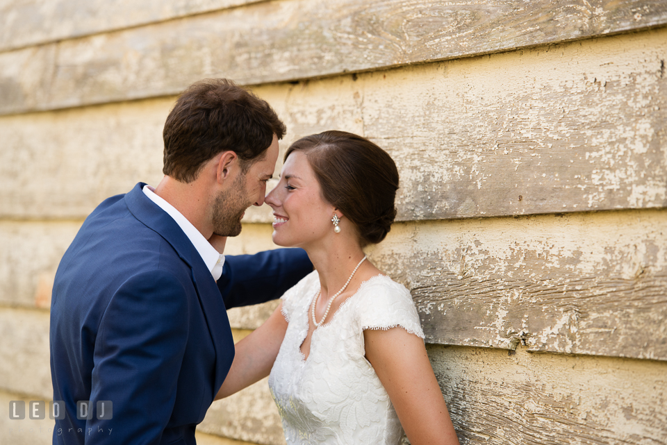 Bride and Groom by the barn touching their noses. The Oaks Waterfront Inn wedding, St Michaels, Eastern Shore, Maryland, by wedding photographers of Leo Dj Photography. http://leodjphoto.com