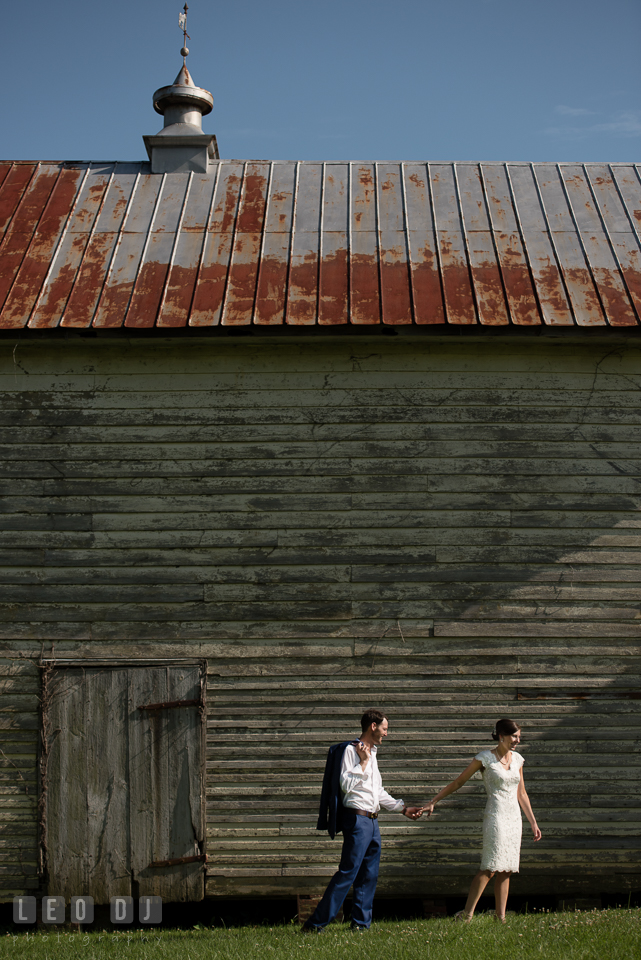 Bride and Groom walking together by the barn. The Oaks Waterfront Inn wedding, St Michaels, Eastern Shore, Maryland, by wedding photographers of Leo Dj Photography. http://leodjphoto.com