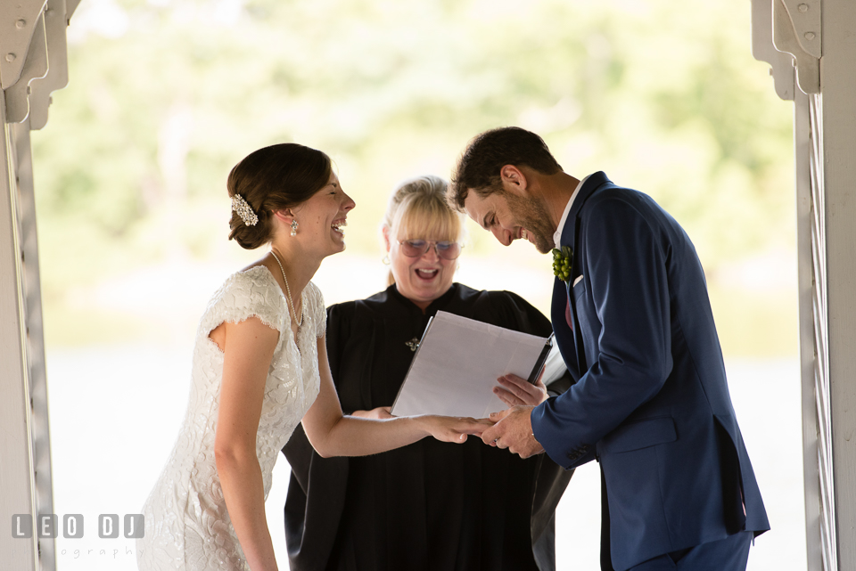 Bride and Groom laughing during their vow and wedding ring exchange. The Oaks Waterfront Inn wedding, St Michaels, Eastern Shore, Maryland, by wedding photographers of Leo Dj Photography. http://leodjphoto.com