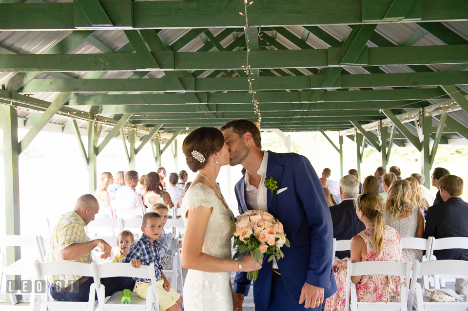 Bride and Groom kissing at the end of the aisle after the ceremony. The Oaks Waterfront Inn wedding, St Michaels, Eastern Shore, Maryland, by wedding photographers of Leo Dj Photography. http://leodjphoto.com