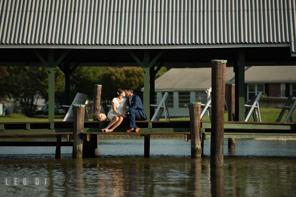 Bride and Groom kissing on the dock. The Oaks Waterfront Inn wedding, St Michaels, Eastern Shore, Maryland, by wedding photographers of Leo Dj Photography. http://leodjphoto.com