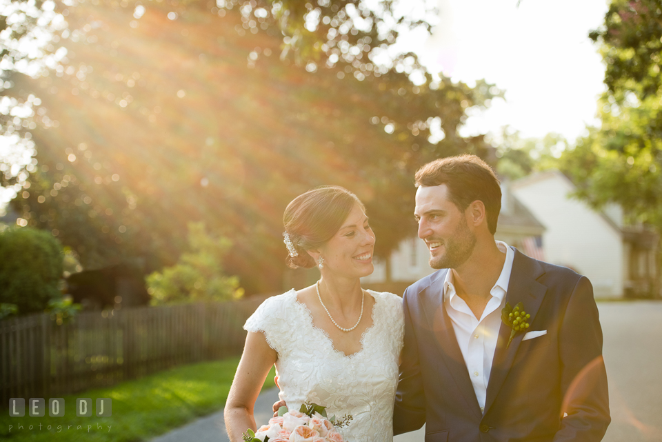 Bride and Groom walking together embracing each other. The Oaks Waterfront Inn wedding, St Michaels, Eastern Shore, Maryland, by wedding photographers of Leo Dj Photography. http://leodjphoto.com