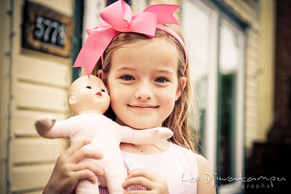 girl, pink ribbon, and her doll. Children family reunion birthday photography Tilghman Island Annapolis Kent Island Eastern Shore MD