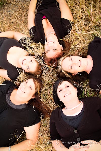 Girls, ladies laying on grassy-ground making circle, smiling. Commercial work photography Annapolis Eastern Shore MD Washington DC