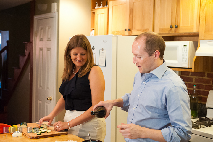 Engaged guy poured olive oil on egg. His fiancée looking. Engagement photo session at town home near Federal Hill Baltimore Maryland by wedding photographers of Leo Dj Photography (http://leodjphoto.com)