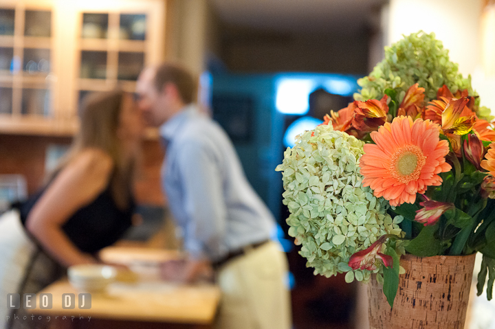 Engaged couple kissing in the kitchen. Engagement photo session at town home near Federal Hill Baltimore Maryland by wedding photographers of Leo Dj Photography (http://leodjphoto.com)