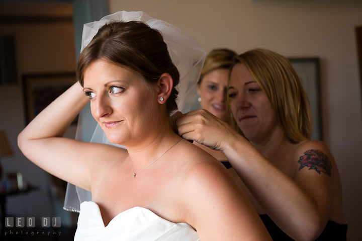 Bridesmaid helping Bride put on necklace. Getting ready and ceremony wedding photos at private estate at Preston, Easton, Eastern Shore, Maryland by photographers of Leo Dj Photography. http://leodjphoto.com