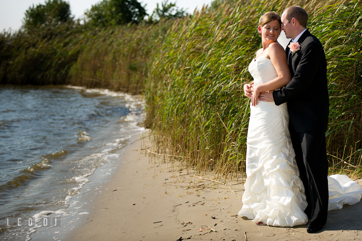 Bride and Groom cuddling on the beach. Getting ready and ceremony wedding photos at private estate at Preston, Easton, Eastern Shore, Maryland by photographers of Leo Dj Photography. http://leodjphoto.com