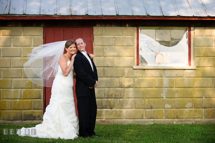 Bride and Groom posing together by a red door. Getting ready and ceremony wedding photos at private estate at Preston, Easton, Eastern Shore, Maryland by photographers of Leo Dj Photography. http://leodjphoto.com