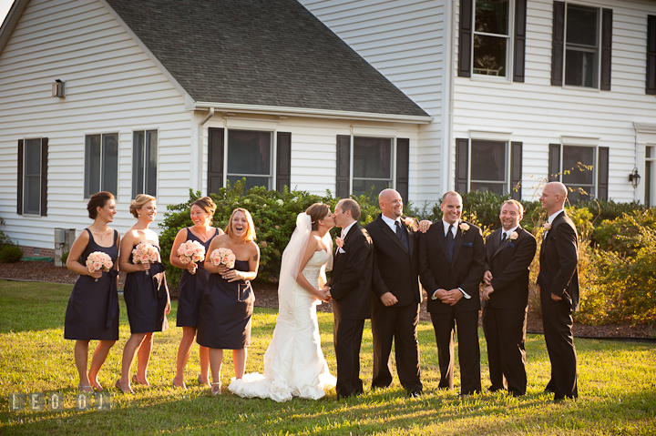 Bride and Groom kissing while posing with wedding party. Reception party wedding photos at private estate at Preston, Easton, Eastern Shore, Maryland by photographers of Leo Dj Photography. http://leodjphoto.com