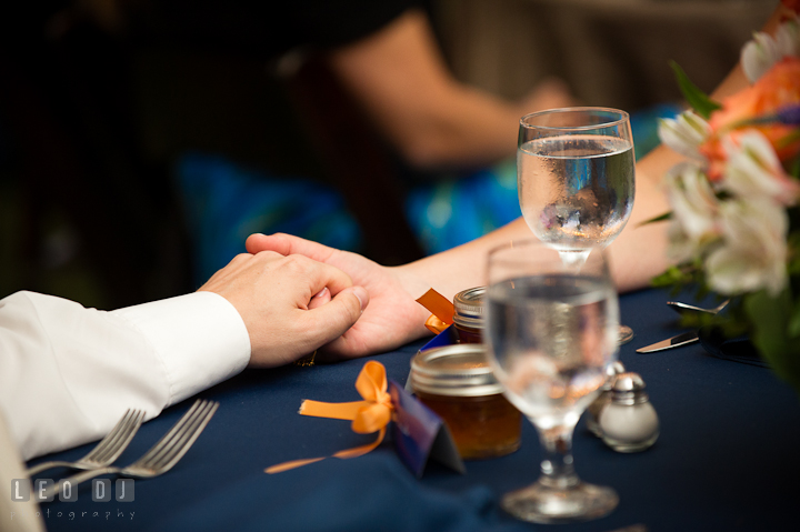 Bride and Groom holding hands at the sweetheart table. Reception party wedding photos at private estate at Preston, Easton, Eastern Shore, Maryland by photographers of Leo Dj Photography. http://leodjphoto.com