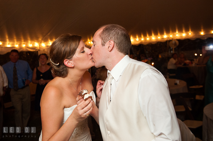 Bride and Groom kissing after feeding cupcakes to each other. Reception party wedding photos at private estate at Preston, Easton, Eastern Shore, Maryland by photographers of Leo Dj Photography. http://leodjphoto.com