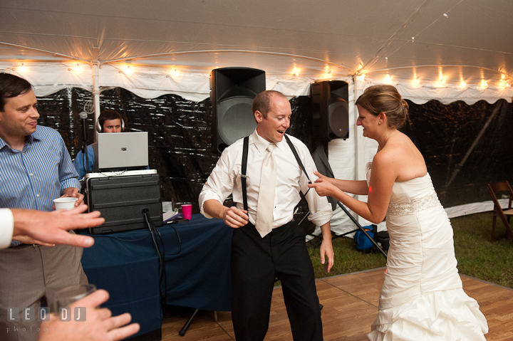 Bride pulling Groom's suspender while dancing. Reception party wedding photos at private estate at Preston, Easton, Eastern Shore, Maryland by photographers of Leo Dj Photography. http://leodjphoto.com