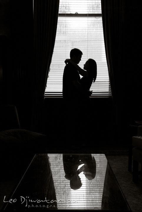 Engaged couple embracing by the window. Tremont Plaza Hotel and Grand Historic Venue Baltimore Pre-wedding Engagement Photo Session by wedding photographers Leo Dj Photography