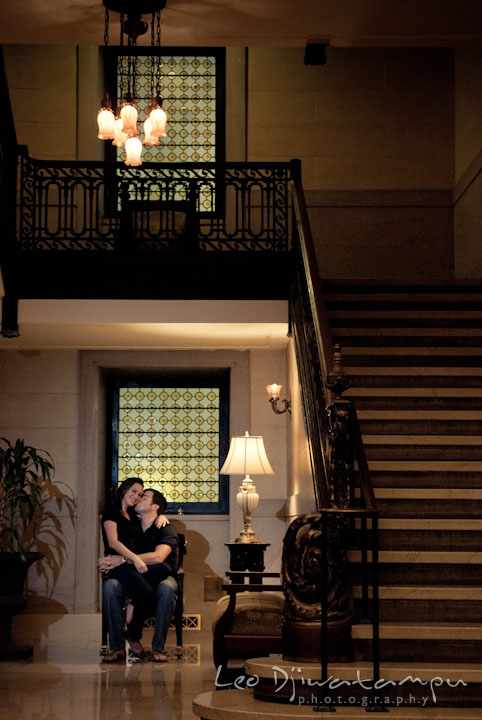 Engaged girl sits on her fiancé's lap. Tremont Plaza Hotel and Grand Historic Venue Baltimore Pre-wedding Engagement Photo Session by wedding photographers Leo Dj Photography