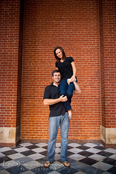 Engaged girl sits on her fiancé's shoulder and arm. Tremont Plaza Hotel and Grand Historic Venue Baltimore Pre-wedding Engagement Photo Session by wedding photographers Leo Dj Photography