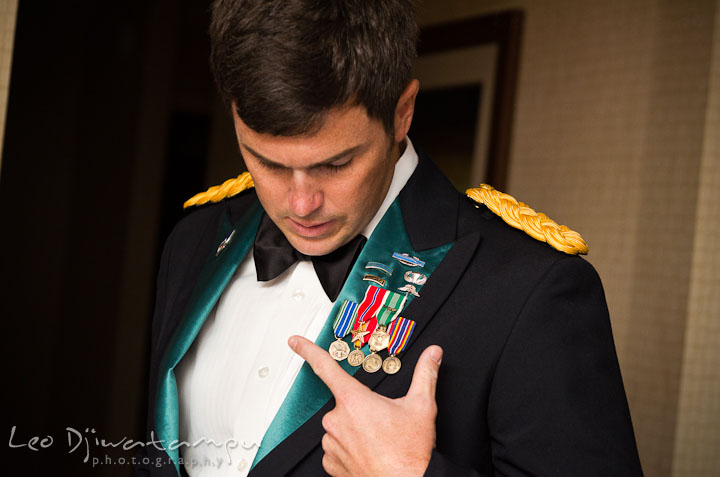 Army groom checking his medals of honor. Baltimore Maryland Tremont Plaza Hotel Grand Historic Venue wedding ceremony and reception photos, by photographers of Leo Dj Photography.