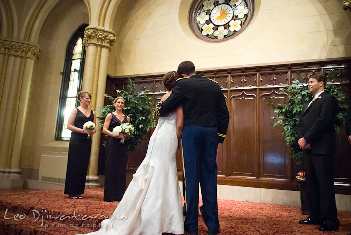 Bride and groom hugged during ceremony. Baltimore Maryland Tremont Plaza Hotel Grand Historic Venue wedding ceremony and reception photos, by photographers of Leo Dj Photography.